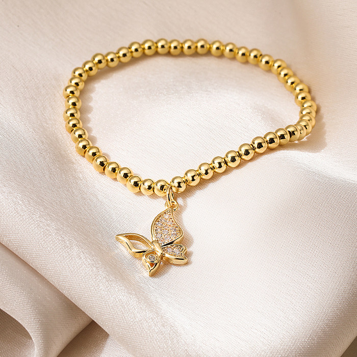 Pulseras chapadas en oro de 18 quilates con incrustaciones de cobre y perlas de imitación de mariposa de viaje de estilo simple