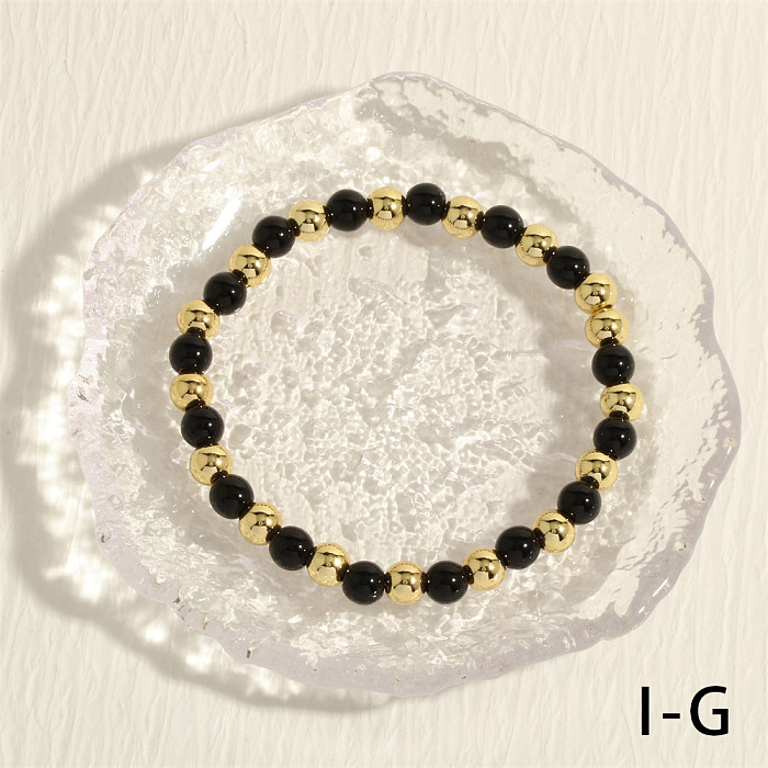 Bracelets plaqués or avec perles de cuivre rondes de couleur unie