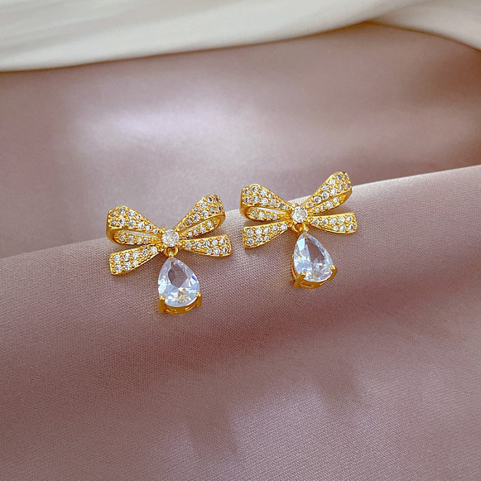 Elegante Glam gotas de agua nudo de lazo acero titanio chapado en cobre incrustaciones diamantes de imitación chapado en oro pendientes collar