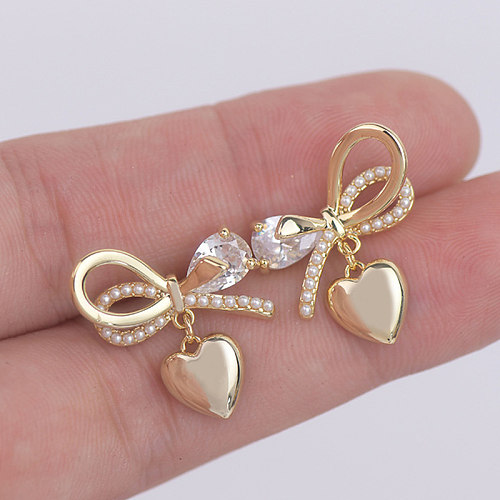 1 Pair Fairy Style French Style Simple Style Heart Shape Bow Knot Plating Inlay Copper Artificial Pearls Zircon 14K Gold Plated Ear Studs