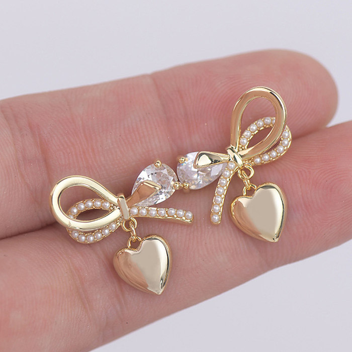 1 Pair Fairy Style French Style Simple Style Heart Shape Bow Knot Plating Inlay Copper Artificial Pearls Zircon 14K Gold Plated Ear Studs