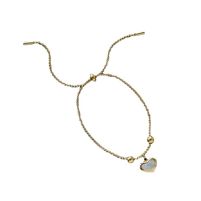 Collar de pendientes chapado en oro de titanio con forma de corazón de viaje de estilo simple