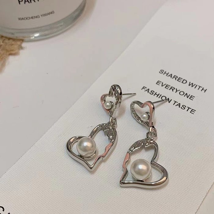 1 paire de boucles d'oreilles plaquées cuivre en forme de cœur, style simple