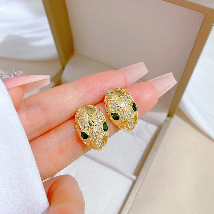1 paire de clous d'oreilles en cuivre avec incrustation de nœud solaire pour dame, pierres précieuses artificielles