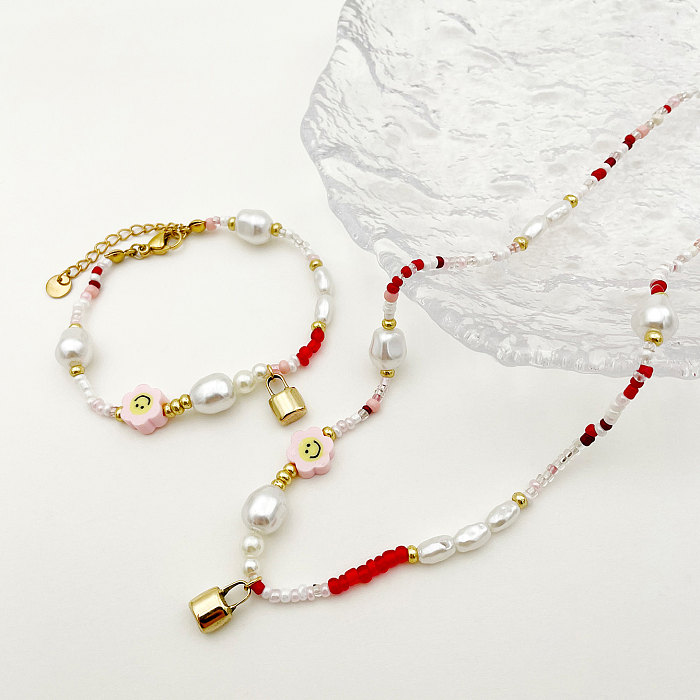Niedliche pastorale Smiley-Blumen-Schloss-Edelstahl-Perlen-Imitationsperlen-Beschichtung, vergoldete Armbänder und Halskette