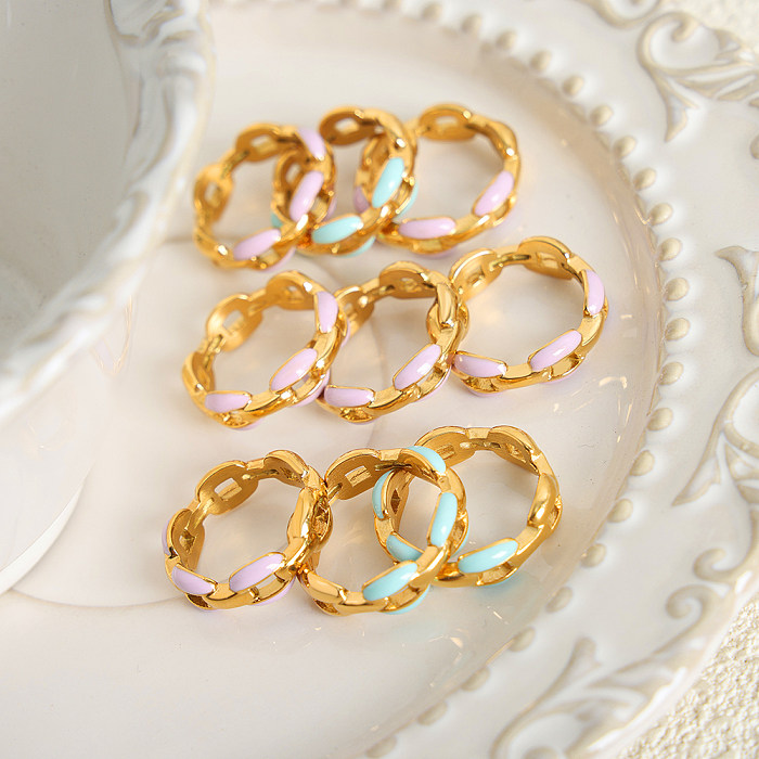 Anillos chapados en oro de 18 quilates con incrustaciones de esmalte de acero de titanio con ondas artísticas dulces de Lolita