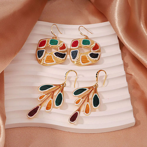 1 paire de boucles d'oreilles pendantes en cuivre plaqué or 18 carats, style streetwear artistique élégant, feuilles irrégulières peintes