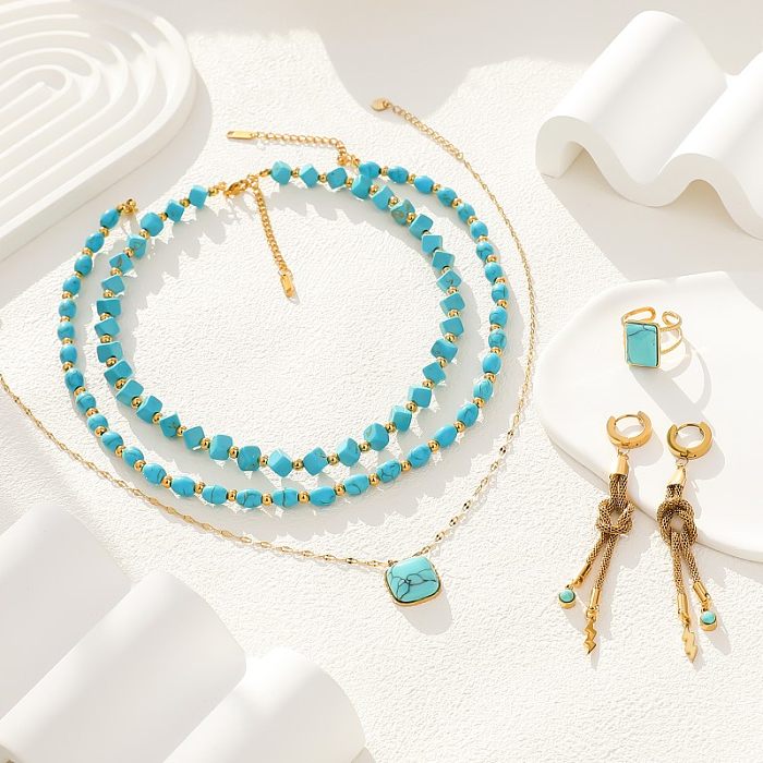 Glamouröse, quadratische Lightning-Halskette aus Edelstahl mit Perlenbeschichtung und Türkis-vergoldeten Ringen, Ohrringen und Halskette