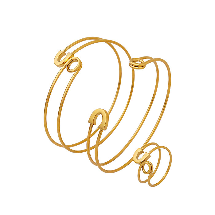 Schlichter Stil mit geometrischen Ringen und Armbändern aus Titanstahl mit 18-Karat-Vergoldung