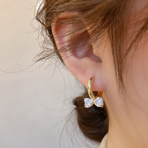 1 paire de boucles d'oreilles en diamant avec incrustation de cuivre et nœud papillon à la mode
