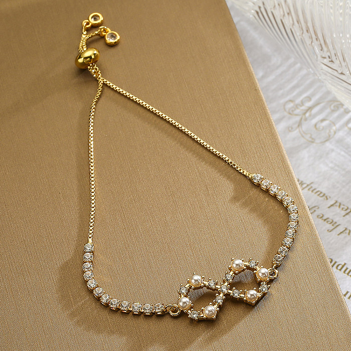 Einfacher Stil, unendliche Herzform, Flügel, Kupferbeschichtung, Intarsien, künstliche Perlen, Zirkon, 18 Karat vergoldete Armbänder