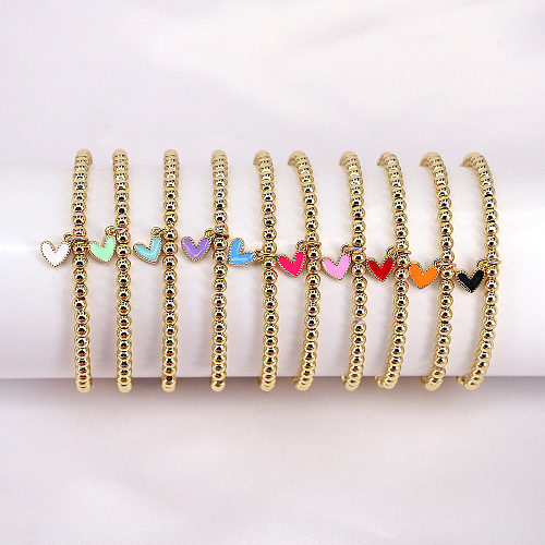 Neues, herzförmiges, elastisches Kupferarmband mit wilden Goldkugeln und Perlen in Farbe und Öltropfen