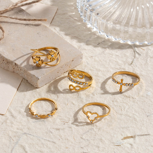 Anillos de diamantes de imitación chapados en oro de 18 quilates de acero inoxidable con forma de corazón infinito cruzado de estilo coreano a granel
