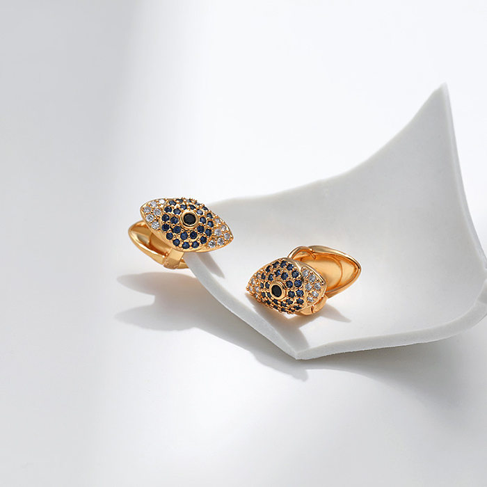 1 par de aretes de diamantes de imitación de cobre con incrustaciones de ojos de estilo simple
