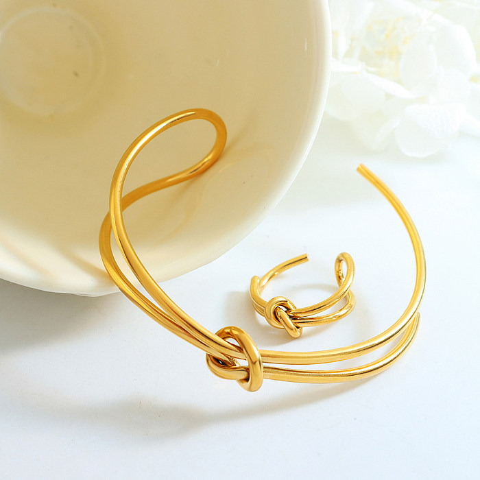 Elegante geometrische Titanstahlbeschichtung mit 18 Karat vergoldeten Ringen und Armbändern