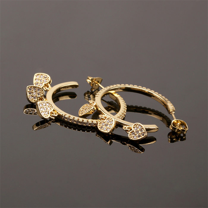 1 paire de boucles d'oreilles en forme de cœur et de croix avec incrustation de cuivre et de papillon en Zircon