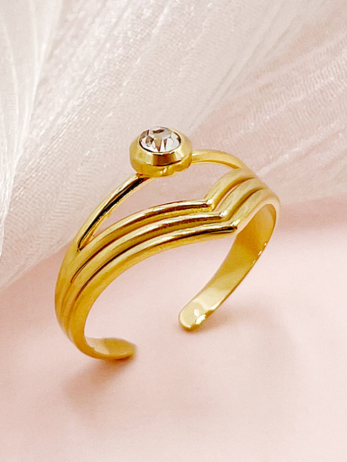 O estilo simples elegante alinha o anel aberto chapeado ouro de aço inoxidável do zircão no volume