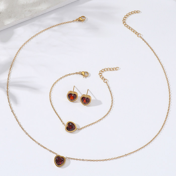 Neues schlichtes Herz-Halsketten-Ohrring-Armband-Set aus Edelstahl mit Granat-Zirkon-Intarsien und 18 Karat Gold