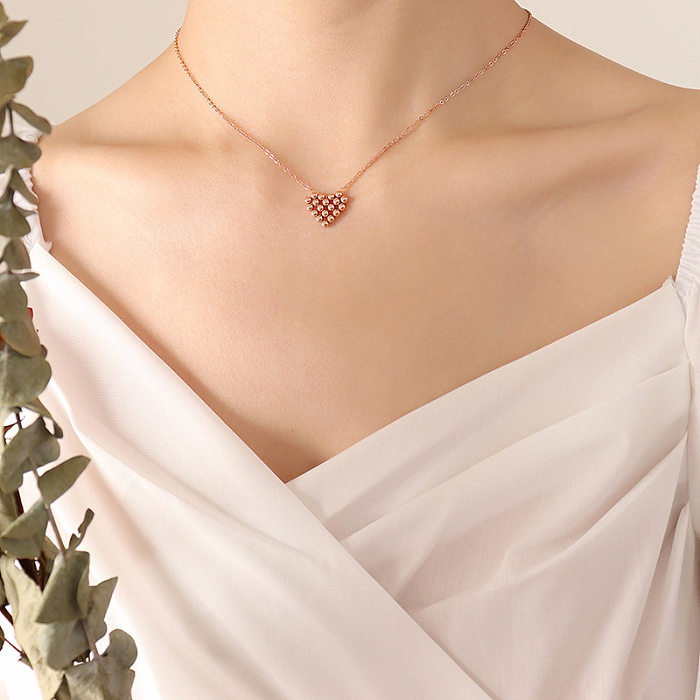 Boucles d'oreilles collier en forme de coeur plaqué or en acier titane simple à la mode