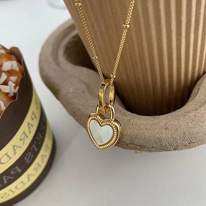 Collier pendentif rétro en forme de cœur avec incrustation de cuivre et coquillage