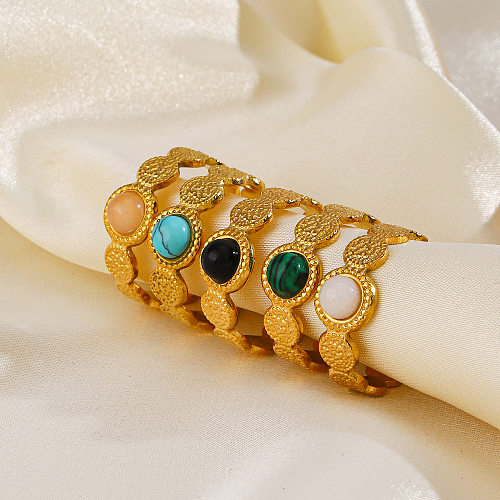 Offener Ring im geometrischen IG-Stil aus Edelstahl und Naturstein mit türkisfarbenem Opal in großen Mengen