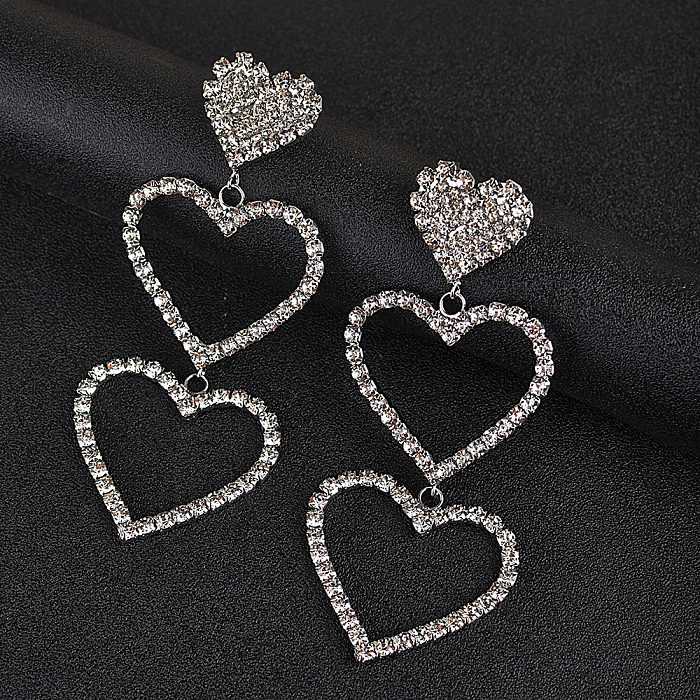 1 par de pendientes colgantes con diamantes de imitación de cobre con incrustaciones en forma de corazón