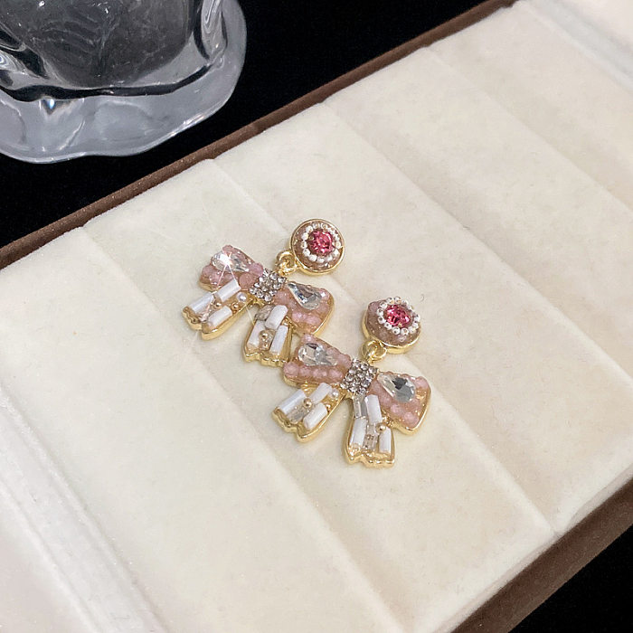 1 par de pendientes colgantes de circonita con perlas artificiales de cobre con incrustaciones de nudo de lazo con borlas glamorosas
