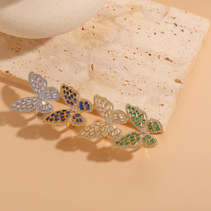 Elegante, klassische Schmetterlings-Kupfer-Asymmetrisch-Überzug-Inlay-Zirkon-14-Karat-vergoldete offene Ringe