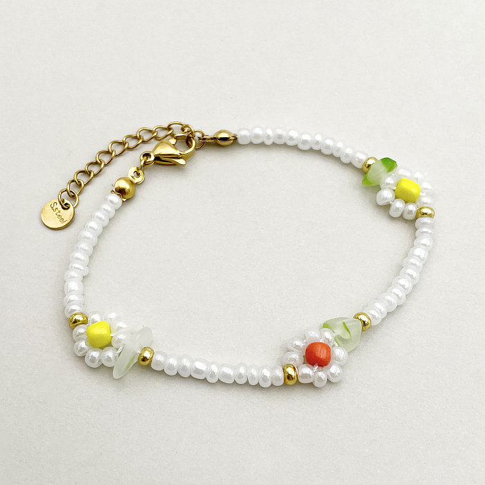 Schlichter Stil, Blumen-Edelstahl-Perlenüberzug, vergoldete Armbänder-Halskette