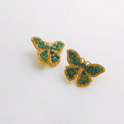 1 paire de clous d'oreilles en résine Zircon avec incrustation de cuivre papillon à la mode