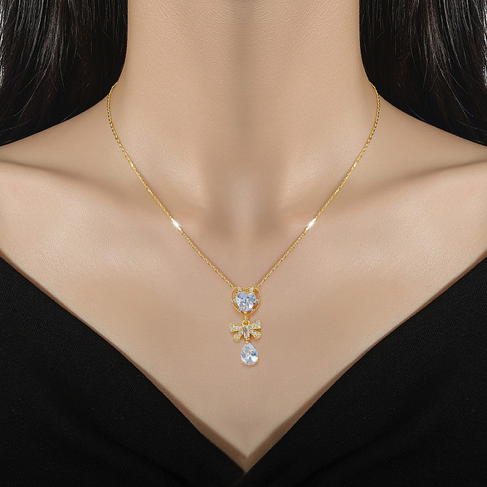 Moderner Pendel-Halskette in Herzform, Schleife, Knoten, Titanstahl, Kupferbeschichtung, Intarsien, künstliche Edelsteine, vergoldete Anhänger-Halskette