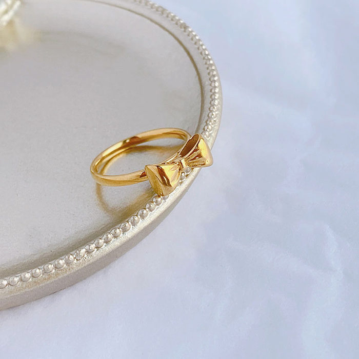 Estilo simples arco nó titânio aço chapeamento anéis banhados a ouro 18K