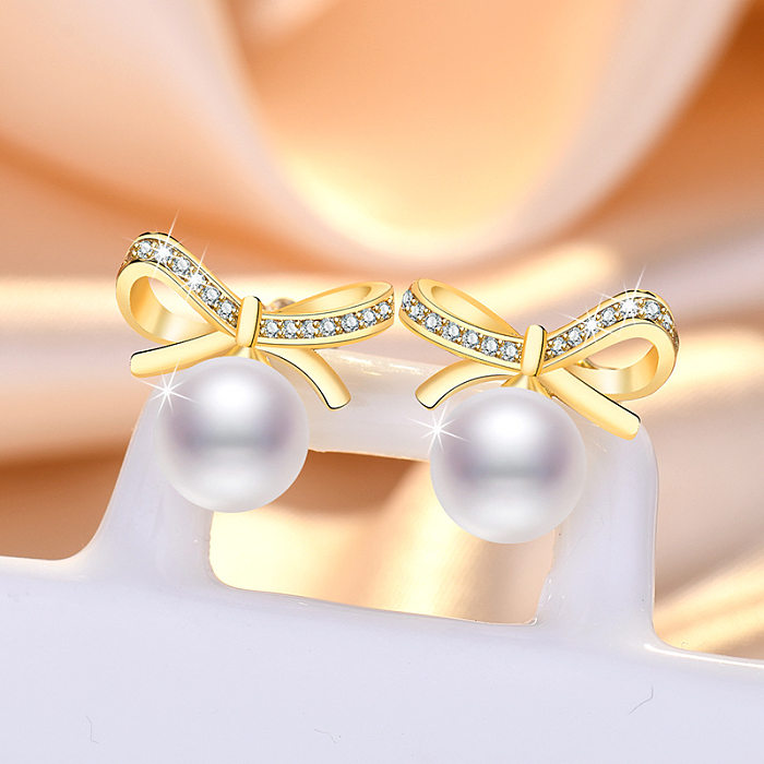 1 Paar süße Blatt-Kronen-Schleifenknoten-Imitat-Perlen-Kupfer-Inlay-Strass-Ohrringe