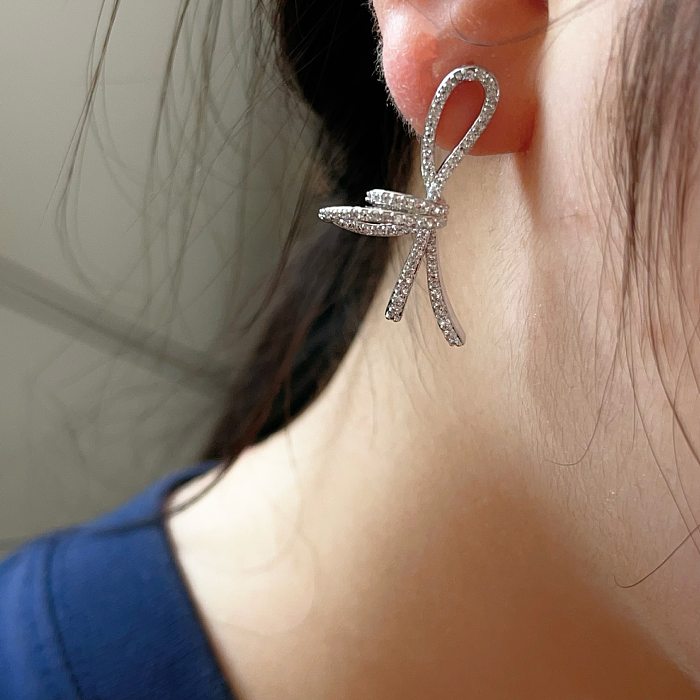 1 paire de boucles d'oreilles élégantes pour femmes, Style Simple, nœud papillon plaqué, incrustation de cuivre et de Zircon