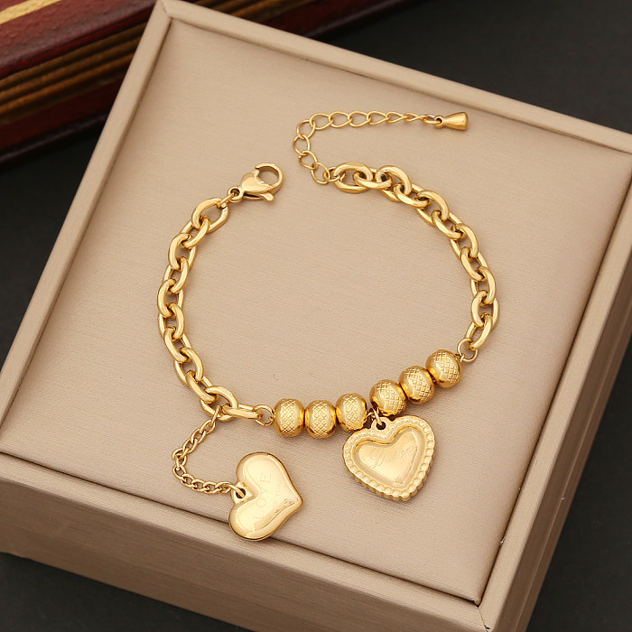Collier de boucles d'oreilles de bracelets des femmes plaquées par or de placage d'acier inoxydable de forme de coeur de mode