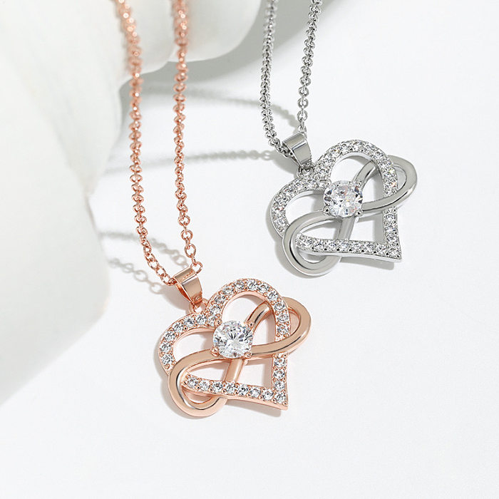 Conmute el collar pendiente de las piedras preciosas artificiales del cobre de la forma del corazón en bulto