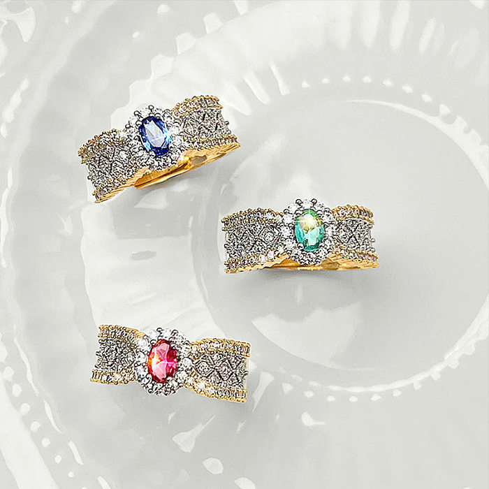 Elegante ovale Verkupferungseinlage mit künstlichen Edelsteinen, vergoldete offene Ringe