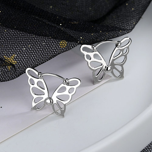 1 paire de clous d'oreilles en cuivre ajourés papillon de style IG