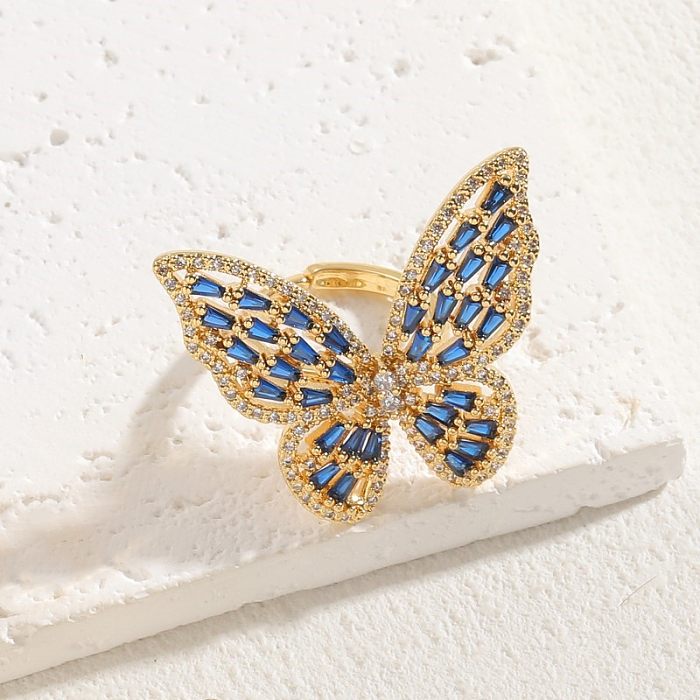 Elegante, klassische Schmetterlings-Kupfer-Asymmetrisch-Überzug-Inlay-Zirkon-14-Karat-vergoldete offene Ringe