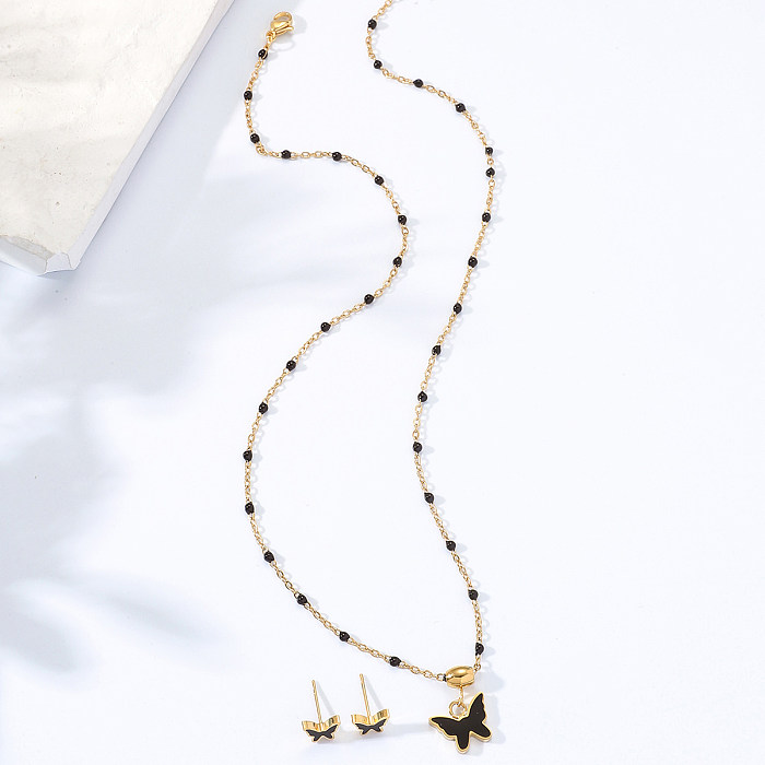 Schlichtes, mit 18 Karat Gold vergoldetes, schwarzes Emaille-Schmetterlings-Halsketten-Ohrring-Set aus Edelstahl