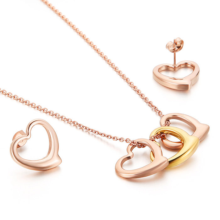 Nuevo conjunto de joyas de pendientes y collar de corazón de melocotón en forma de corazón de acero inoxidable europeo y americano