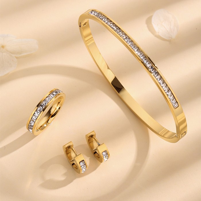 Elegante, runde, einfarbige Titanstahlbeschichtung mit Strasssteinen und 18 Karat vergoldeten Ringen, Armbändern und Ohrringen