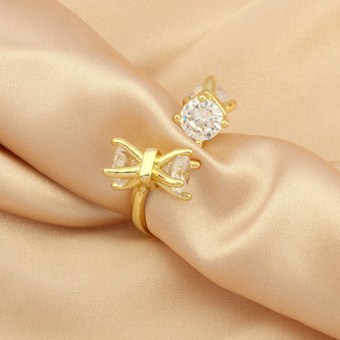 Elegante offene Ringe mit Schleifenknoten, Kupferbeschichtung und Zirkoneinlage, 18 Karat vergoldet