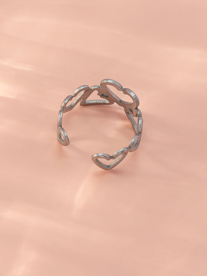 Le style simple laisse les anneaux ouverts creux d’acier inoxydable de forme de coeur
