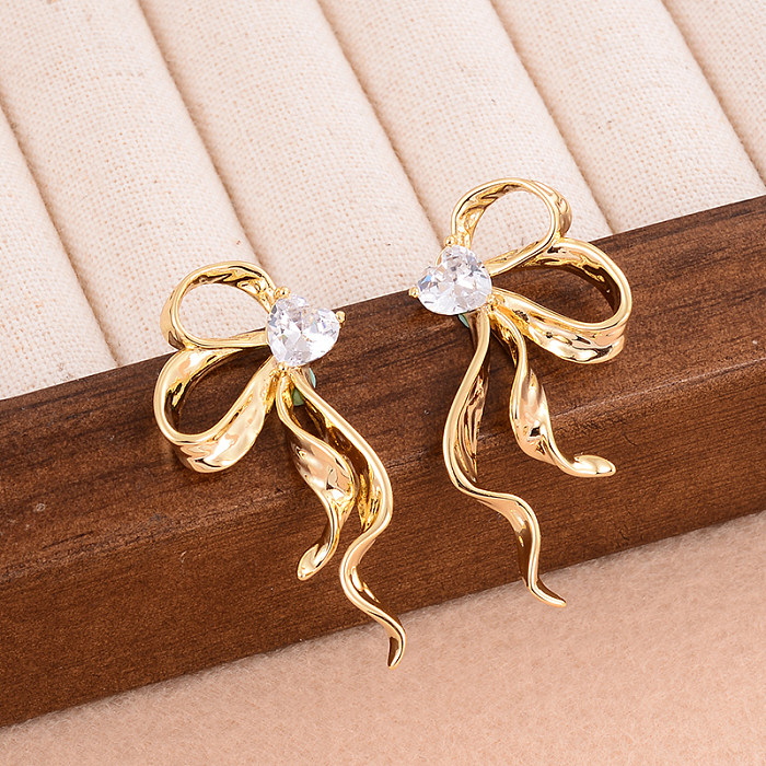 1 Paar Ohrstecker im IG-Stil mit glänzender Schleife, Knotenplattierung, Inlay, Kupfer-Zirkon, 14 Karat vergoldet