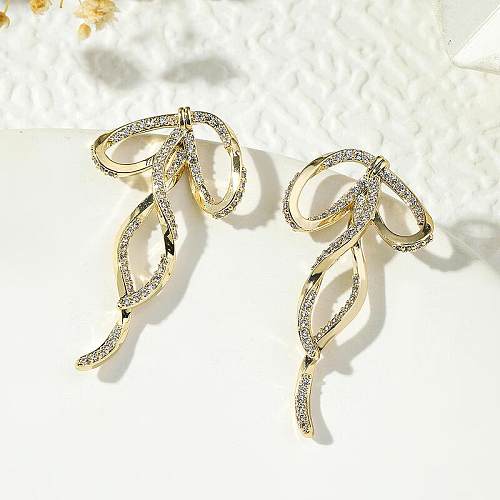 1 paire de boucles d'oreilles luxueuses et brillantes avec incrustation de nœud papillon en cuivre et Zircon plaqué or 18 carats