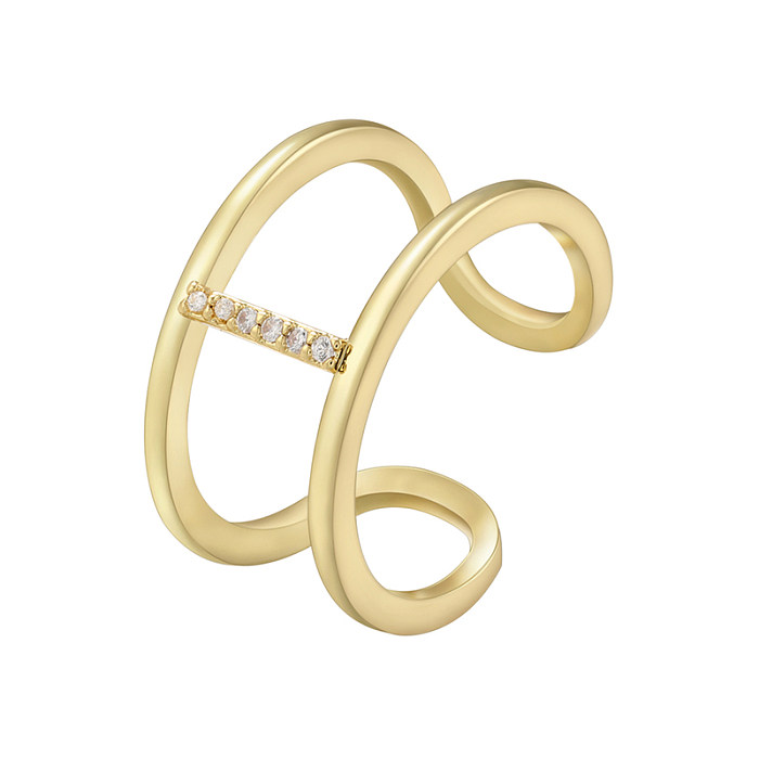 Eleganter offener Ring mit Buchstabenverkupferung und Zirkoneinlage, 18 Karat vergoldet