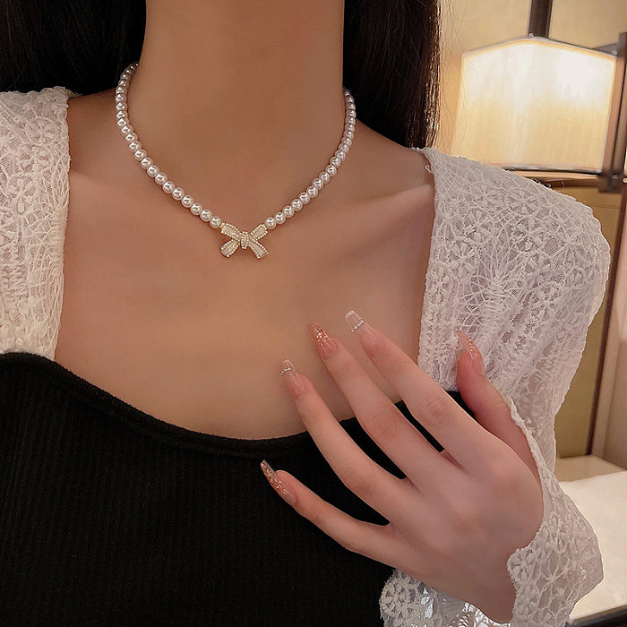 Collar de perlas artificiales con incrustaciones de acero inoxidable con nudo de lazo de estilo coreano básico de estilo nórdico
