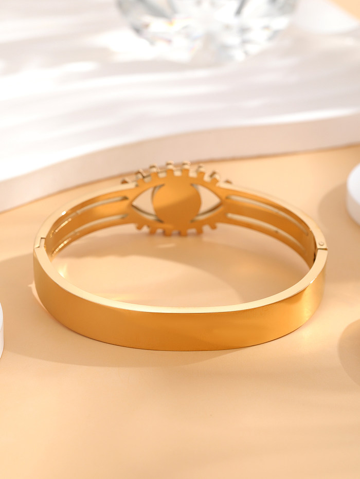 Brazalete chapado en oro de diamantes de imitación con incrustaciones de epoxi de acero de titanio con ojo artístico