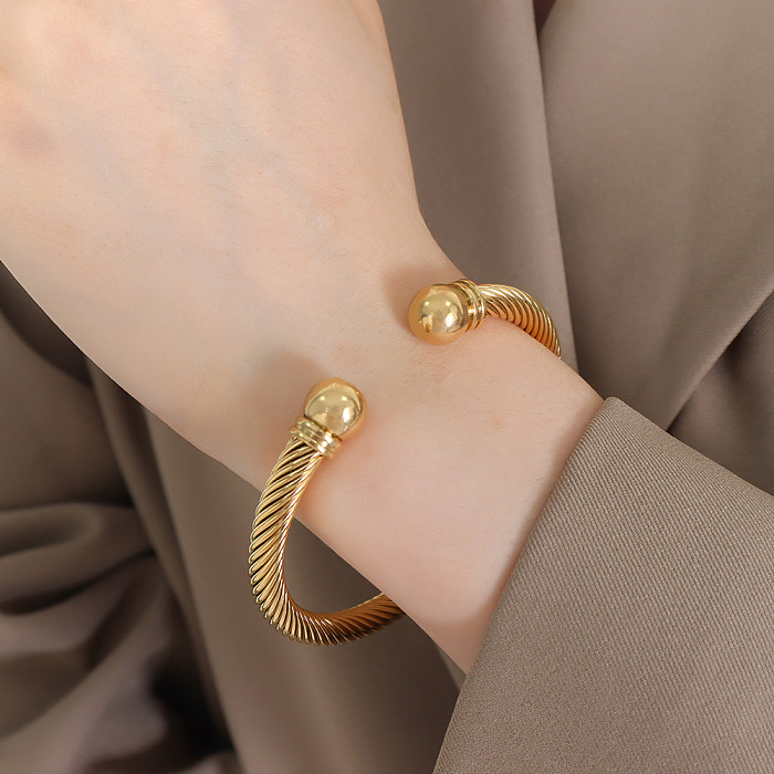 Einfaches, einfarbiges Armband aus Titanstahl mit 18-Karat-Vergoldung und gedrehtem Kabel